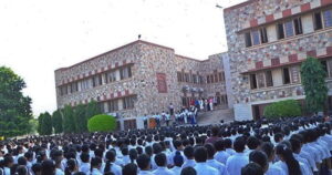A lot of students in white shirts in front of Xavier's Senior Secondary School